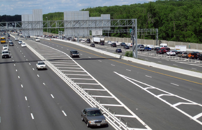 Photo of I-495 general purpose and Express Lanes in Fairfax County, VA. Many vehicles are traveling in both directions, the managed lanes are separated from the general lanes with plastic posts and white paint.