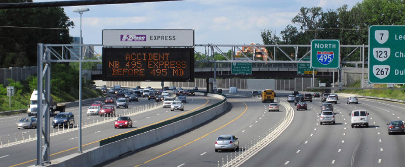 Photo of dynamic message sign positioned over the highway which is indicating an accident ahead in the northbound I-495 Express Lanes.