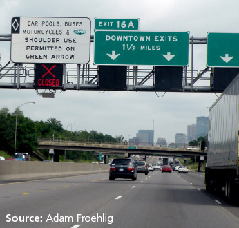 Photo of overhead highway sign indicating that the HOV lane is closed on the I-35W PDSL in Minneapolis.