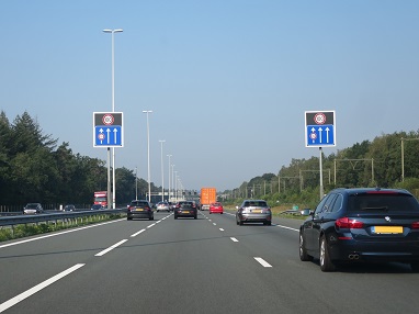 Photo shows a car using the left shoulder lane for travel in Netherlands.