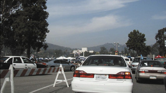 Photograph of cars waiting in traffic to enter an event parking lot.