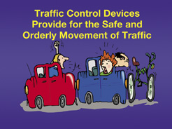 Cartoon illustration showing two cars and a bicycle involved in rear and front-end collisions. The text in the cartoon says, "Traffic control devices provide for the safe and orderly movement of traffic."