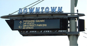 Photo. Dynamically changing sign providing real-time parking-related information in downtown Los Angeles.  Example of an APM strategy in use – dynamic wayfinding.