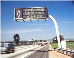 Picture displaying overhead sign reading "Express Lanes Carpools Only Second Exit".
