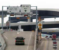 Photo. Overhead signs identifying 'Little York Park & Ride' and '290 HOV West' lanes in Houston, Texas.
