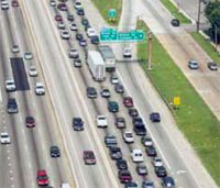 Photo. Aerial photo of Houston HOV lanes and general purpose lanes in use.  Heavier traffic is on the general purpose lanes