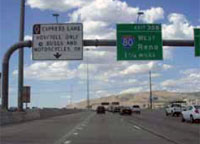 Photo. Overhead signs identifying an HOV/Toll only lane in Salt Lake City, Utah.