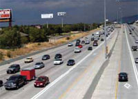 Photo. View of a Salt Lake City roadway with vehicles using toll lane and general purpose lanes.  The toll lane is less congested.