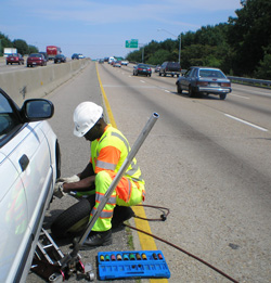 Service patrol changing tire on side of freeway