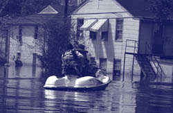 Photo. A manned rescue boat searching a town during a major flood.