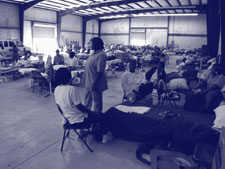 Photo. A shelter house with cots providing refuge for evacuees.