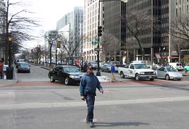 photograph of a man crossing a street that intersects K Street in the area of study. At the intersection shown, there is a pullout area along K Street for buses and other access to local businesses. Pedestrian interaction within the boulevard was analyzed as part of the study.