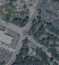 design alternative developed for the study intersection, created by placing sketches over an aerial photo. The sketch is a modern single-lane roundabout design reflecting the functional geometric characteristics and right-of-way impacts of this alternative.