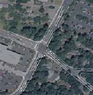 another design alternative developed for the study intersection, created by placing sketches over an aerial photo. The sketch is a signalized intersection design including left and right turn lanes on the intersection approaches. It reflects the functional geometric characteristics and right-of-way impacts of this alternative.