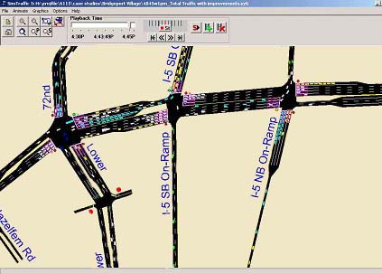 screen capture of a SimTraffic simulation model. The figure shows the area around the SW Lower Boones Ferry Road and I-5 interchange, with small rectangles representing vehicles on the roadway. The figure shows some of the vehicles queuing at the intersections.