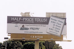 Photo. A sign showing “shoulder” time periods when discount tolls are in effect on two bridges in Ft. Meyers as part of the variable pricing in Lee Count, FL.