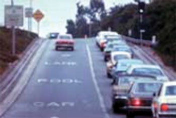 Photo. Highway scene depicting a special-use ramp on a highway and illustrating the difference in the amount of traffic between the HOV lane and the normal lanes.
