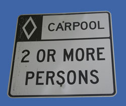 Photo. A carpool sign advises motorists that the lane is for two or more persons only.