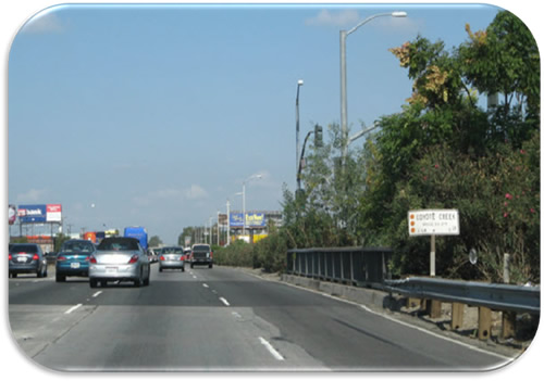 Figure 10. Photo. Converted Shoulders on I-5-California (Photo Courtesy of CALTRANS). Photo showing an urban freeway with the right shoulder permanently converted for use by all traffic.
