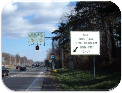 Figure 17. Photo. I-66 Hours of Use Regulatory Sign (Photo Courtesy of  VDOT). Photo of ground-mounted regulatory sign indicating hours of shoulder use: "USE THIS LANE 5:30-10:00 AM MON-FRI ONLY.