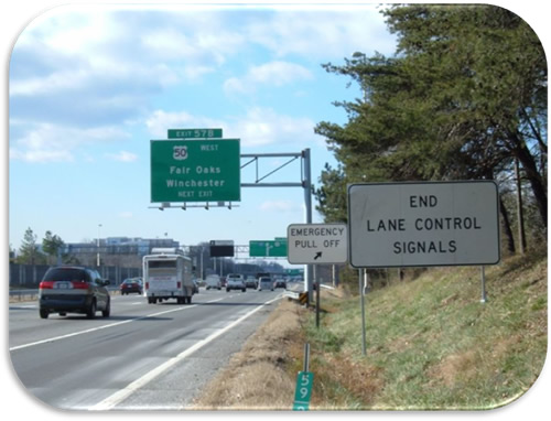 Figure 18. Photo. I-66 Regulatory Signs (Photo Courtesy of VDOT).  Photo of regulatory signs indicating that the shoulder use is ending and the presence of an Emergency Pull Off. A regulatory sign reads "END LANE CONTROL SIGNALS" and another regulator sign reads "EMERGENCY PULL OFF" with an arrow pointing up and to the right.