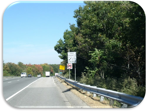 Figure 21. Photo. Regulatory Shoulder Use Signs (Photo Courtesy of MassDOT). Photo of regulatory signs indicating that the shoulder is open to users during specified times and that no trucks are allowed to use the shoulder.