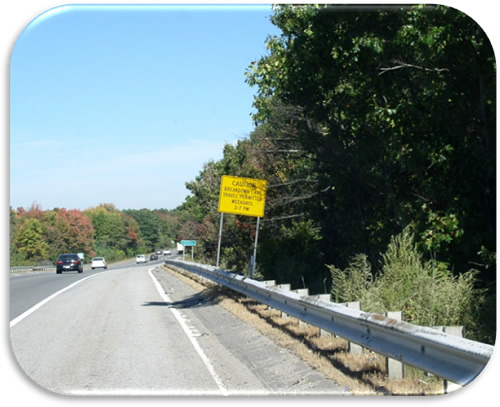 Figure 22. Photo. Warning Shoulder Use Sign (Photo Courtesy of MassDOT). Photo of warning signs indicating that the breakdown lane is used for travel during specified times.