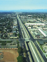 Figure 3 - photo - Figure 3 shows an aerial photograph of the Alameda Corridor flanked on both sides by the local roadway.