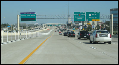Photo of the I-10 Katy Freeway showing the general-purpose lanes, barrier, and managed lanes in one direction.