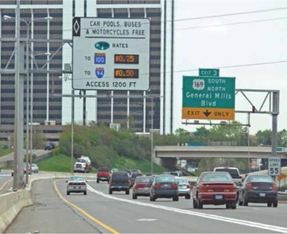 Figure 3 is a picture of cars on the highway, with an high-occupancy tolls lane on the far left, and two normal lanes on the right.