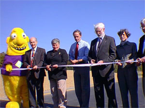 Photo of the Traffic Creep character with officials at a ribbon-cutting ceremony