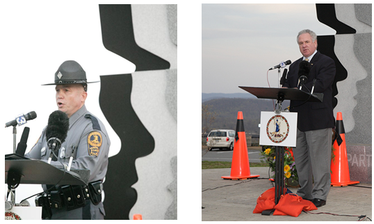 The VDOT Workers Memorial Wall with a series of orange traffic cones draped in black ribbons set up around it.