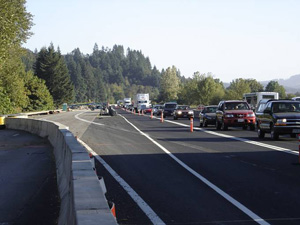 Photo of traffic in lane next to temporary lane marked with cones
