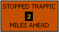 Graphic of an orange message sign displaying Stopped Traffic 2 Miles Ahead.