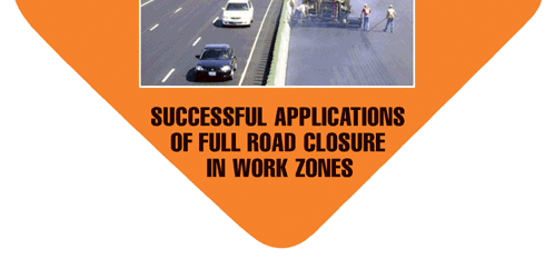 Picture shows one direction of roadway fully closed to traffic with workers laying asphalt.  The roadway is open in the opposite direction with traffic flowing.