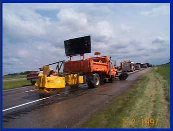Photo of a work zone attenuator vehicle that has been crashed into and badly damaged by a vehicle.