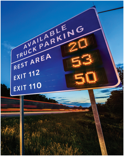 a dynamic messaging sign displaying available truck parking spaces at a rest area and at two exits