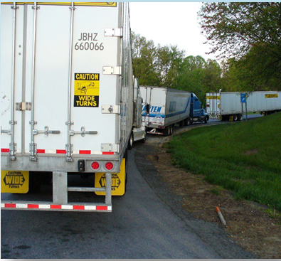 A line of freight trucks viewed from behind.