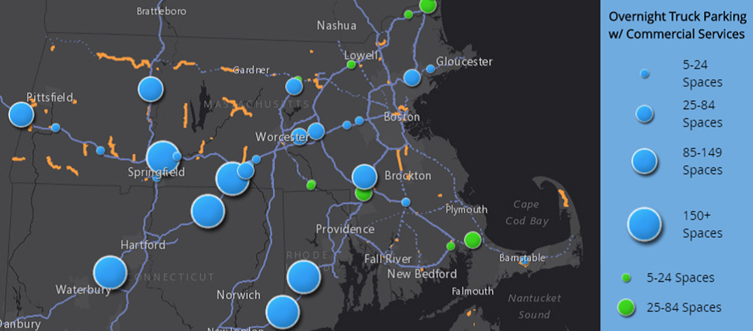 A Map of Massachusetts, Connecticut, and Rhode Island, marked with blue circles of varying sizes denoting the range of the quantity of parking spaces at overnight truck parking locations that include commercial services.