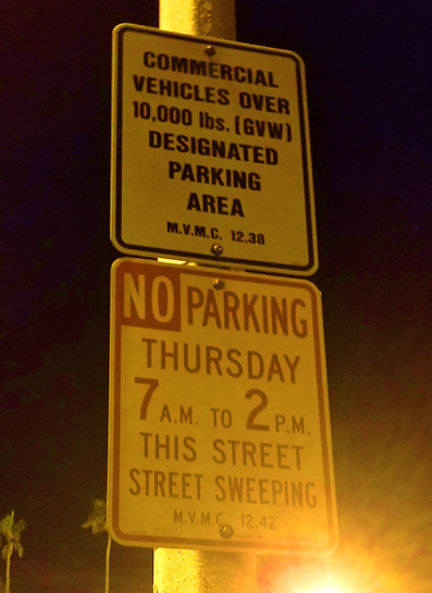 Signs posted in an industrial area in Moreno, CA restricting parking to commercial vehicles.