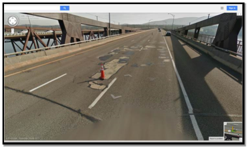 Photo of potholes and repair patches in the center lane of Newburgh Beacon Bridge (I-84) Eastbound. Photo provided by Google Maps