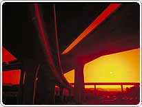 sunset behind a highway interchange
