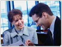 man and woman in office smiling