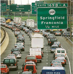 An image of vehicles on an interstate in congested traffic