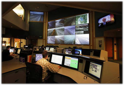 Tyler Elkins, traffic operator, works in the control room during an open house at the Utah Department of Transportation's Traffic Operations Center in Salt Lake City, Wednesday, Oct. 30, 2013. He monitors situations that impact traffic and sends out messages to the public.