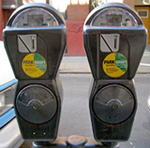 Photo. Two New York City parking meters with fees that dynamically change based on demand and availability.  Example of an APM strategy in use – dynamically priced parking.