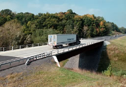 An image of a freight truck crossing a bridge.