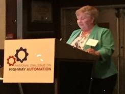 Image of Federal Highway Administration Illinois Division Administrator, Catherine Batey speaking at a podium.
