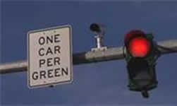 An overhead ramp signal with message "One Car Per Green"