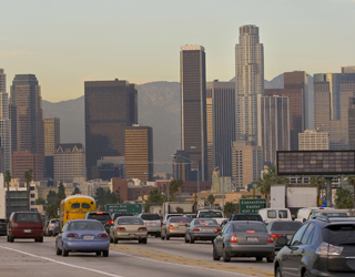 Cover graphic shows a view of mountains in the background, the Los Angeles skyline in the middle ground, and several lanes of highway traffic in the foreground moving toward the convention area.